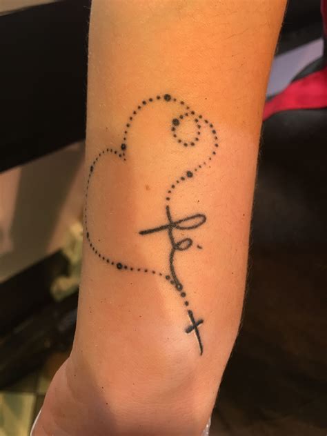 Jesus in the cross tattoo. . Feminine rosary tattoo on foot